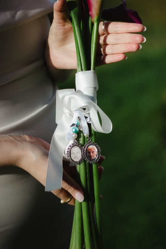 A wedding bouquet with memorial photo charms